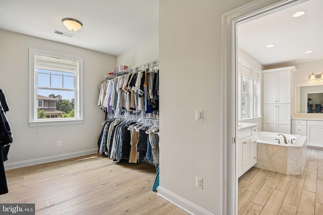 41550 Hepatica Ct, Ashburn, VA 20148 - walk in closet with light wood-type flooring