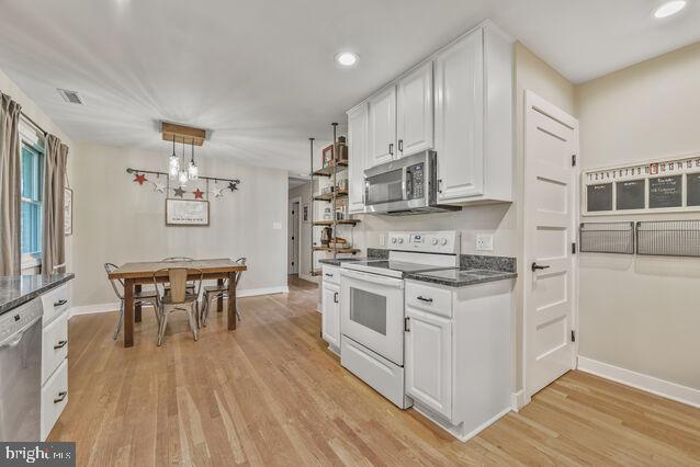32 Hamilton Terrace Dr, Hamilton, VA 20158 - kitchen featuring stainless steel appliances, white cabinets, light wood-style flooring, recessed lighting, and dark stone countertops