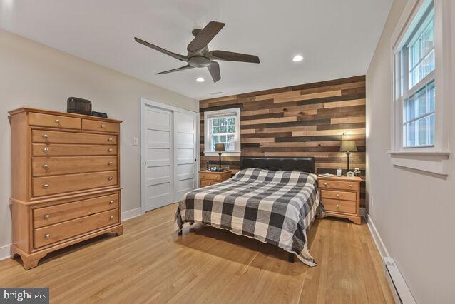 32 Hamilton Terrace Dr, Hamilton, VA 20158 - bedroom featuring light wood-type flooring, recessed lighting, wood walls, a closet, and ceiling fan