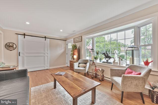 32 Hamilton Terrace Dr, Hamilton, VA 20158 - living room featuring ornamental molding, a barn door, light wood finished floors, and recessed lighting