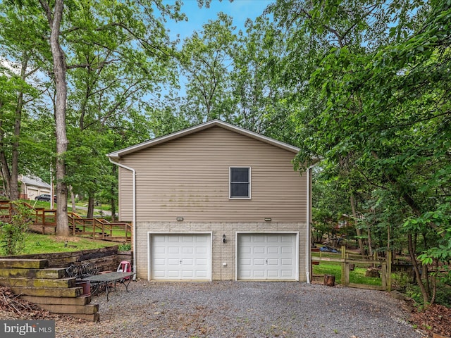 237 Lakeview Dr, Cross Junction, VA 22625 - view of property exterior with brick siding, an attached garage, and gravel driveway
