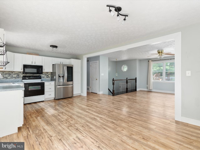 237 Lakeview Dr, Cross Junction, VA 22625 - kitchen with range with electric cooktop, black microwave, stainless steel fridge with ice dispenser, light wood finished floors, and a textured ceiling