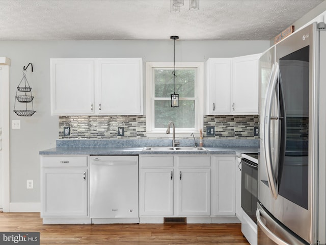 237 Lakeview Dr, Cross Junction, VA 22625 - kitchen featuring white appliances, a textured ceiling, white cabinetry, backsplash, and light wood finished floors