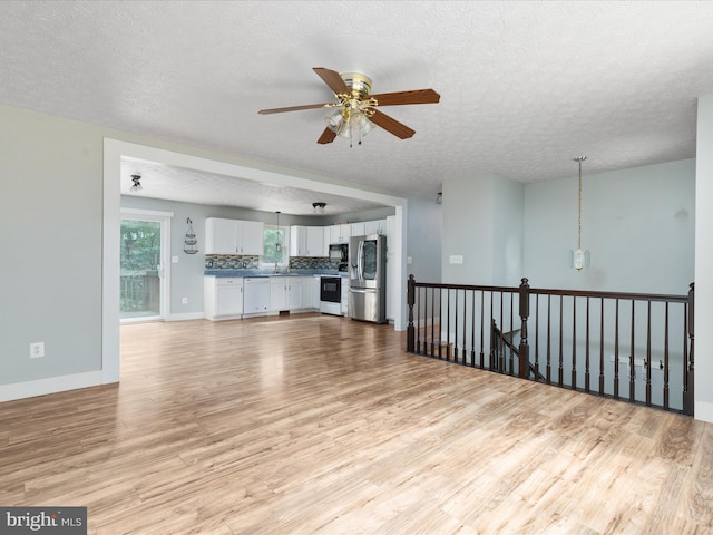 237 Lakeview Dr, Cross Junction, VA 22625 - unfurnished living room with light wood finished floors, a ceiling fan, and a textured ceiling