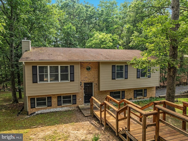 237 Lakeview Dr, Cross Junction, VA 22625 - split foyer home featuring a chimney, roof with shingles, brick siding, and a deck