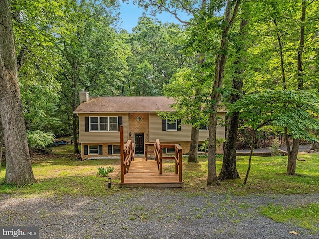 237 Lakeview Dr, Cross Junction, VA 22625 - raised ranch with a chimney, brick siding, a view of trees, and a wooden deck