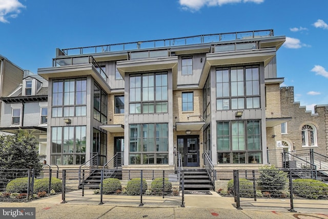 625 Park Rd NW Unit 206, Washington, DC 20010 - multi unit property featuring a fenced front yard, brick siding, and board and batten siding