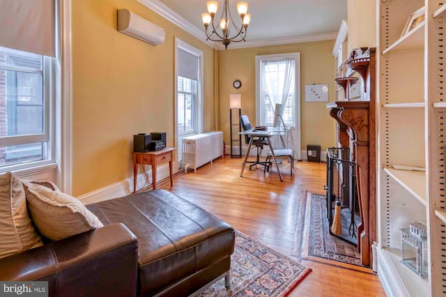 2116 Green St, Philadelphia, PA 19130 - office featuring radiator heating unit, an AC wall unit, ornamental molding, a chandelier, and light wood-style flooring