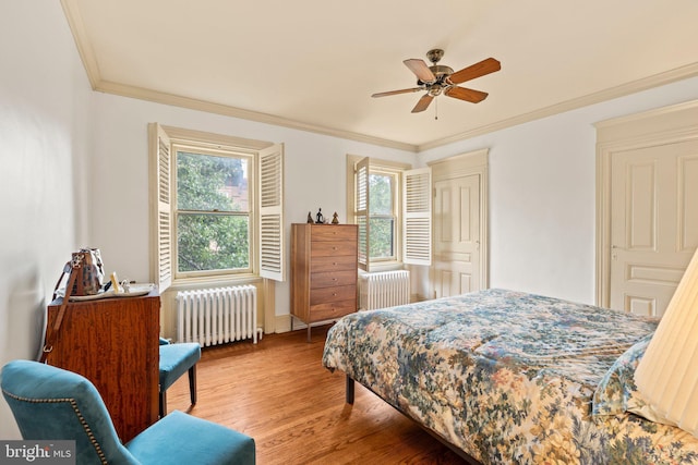 2116 Green St, Philadelphia, PA 19130 - bedroom featuring radiator, wood finished floors, ornamental molding, and ceiling fan