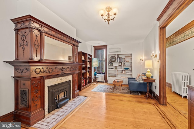 2116 Green St, Philadelphia, PA 19130 - living area featuring radiator, a wall unit AC, and light wood finished floors