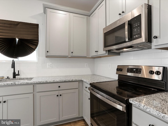 76 Diving Scaup Rd, Hedgesville, WV 25427 - kitchen featuring stainless steel appliances, tasteful backsplash, gray cabinetry, and light stone countertops
