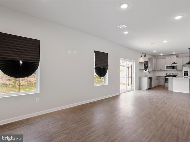 76 Diving Scaup Rd, Hedgesville, WV 25427 - unfurnished living room featuring light wood-style flooring and recessed lighting