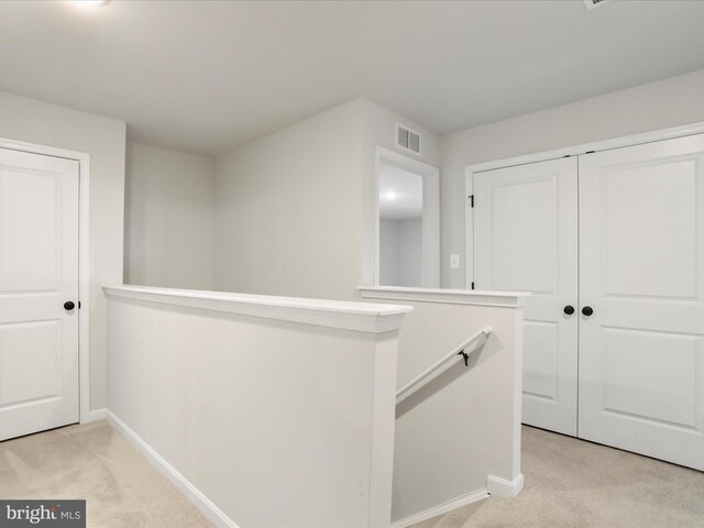 76 Diving Scaup Rd, Hedgesville, WV 25427 - corridor featuring light carpet and an upstairs landing