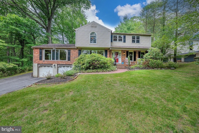 840 Old State Rd, Berwyn, PA 19312 - view of front of house featuring driveway, an attached garage, covered porch, brick siding, and a front yard