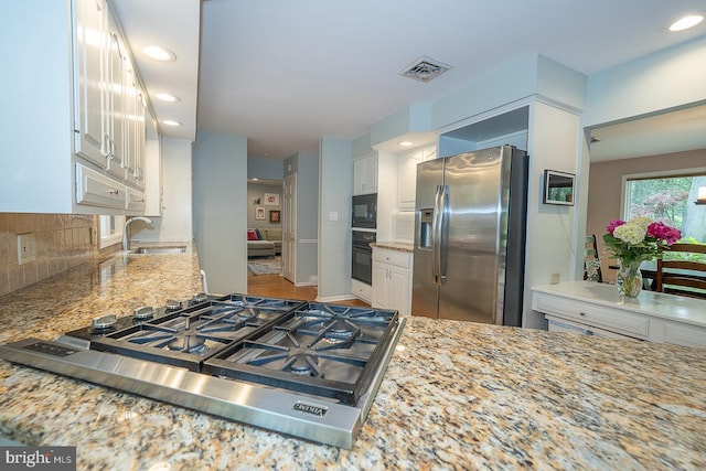 840 Old State Rd, Berwyn, PA 19312 - kitchen with black appliances, light stone counters, backsplash, white cabinets, and recessed lighting