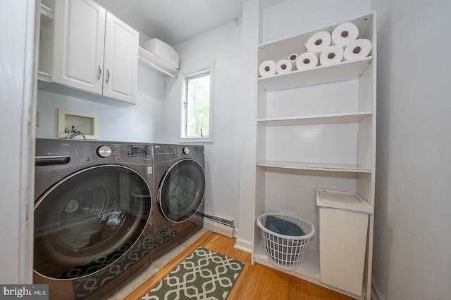 840 Old State Rd, Berwyn, PA 19312 - washroom with washer and clothes dryer, cabinet space, a baseboard heating unit, and light wood-style floors