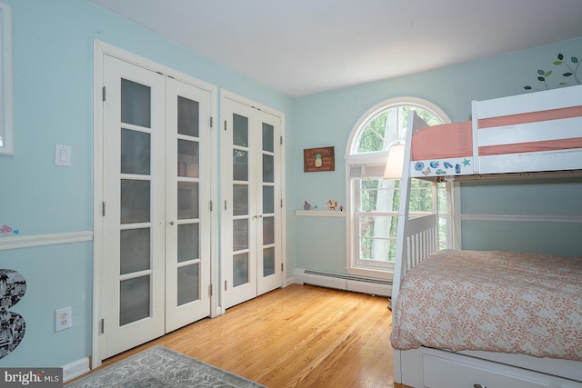 840 Old State Rd, Berwyn, PA 19312 - bedroom featuring a baseboard heating unit, wood finished floors, and french doors