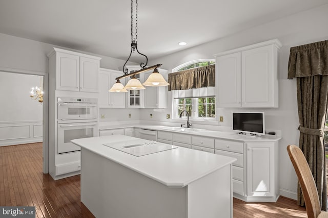 6 Shadybrook Rd, Mullica Hill, NJ 08062 - kitchen featuring white appliances, white cabinets, a kitchen island, dark wood finished floors, and light countertops