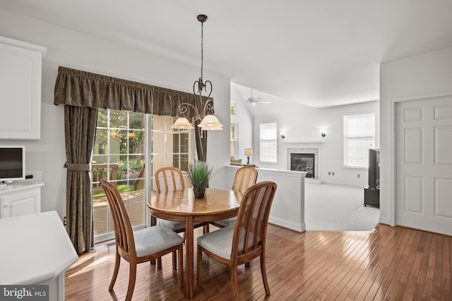 6 Shadybrook Rd, Mullica Hill, NJ 08062 - dining area with a glass covered fireplace, healthy amount of natural light, and light wood finished floors