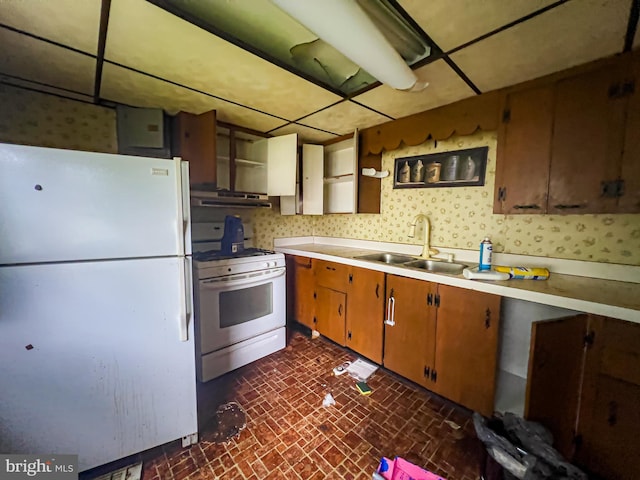 430 Bayard St, Kane, PA 16735 - kitchen with white appliances, brick patterned flooring, light countertops, wallpapered walls, and brown cabinets