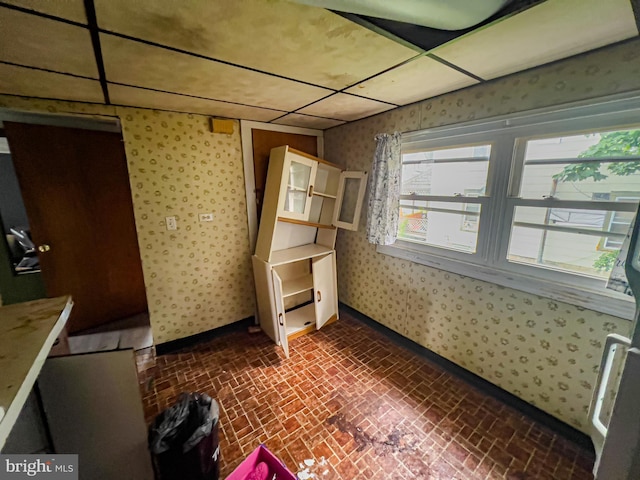 430 Bayard St, Kane, PA 16735 - unfurnished dining area featuring wallpapered walls and brick patterned floors