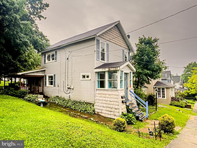430 Bayard St, Kane, PA 16735 - view of side of home featuring a yard, a sunroom, and an outdoor structure