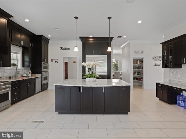 11509 Asbury Ridge Ct, Nokesville, VA 20181 - kitchen with appliances with stainless steel finishes, decorative backsplash, a center island, crown molding, and recessed lighting