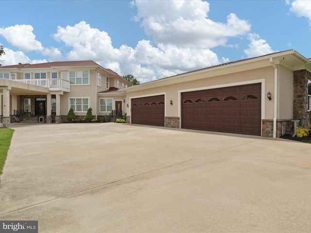 11509 Asbury Ridge Ct, Nokesville, VA 20181 - view of front of home featuring stone siding, driveway, and stucco siding
