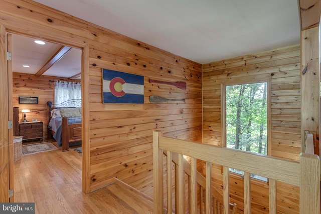 379 Wintergreen Way, Berkeley Springs, WV 25411 - corridor featuring an upstairs landing, wooden walls, and light wood-style floors