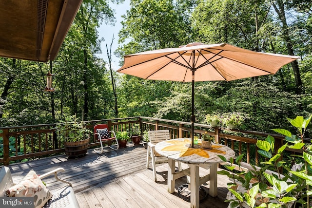 379 Wintergreen Way, Berkeley Springs, WV 25411 - deck featuring outdoor dining space and view of wooded area