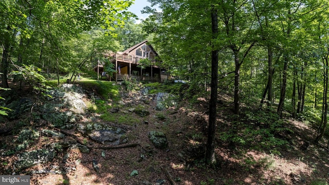 379 Wintergreen Way, Berkeley Springs, WV 25411 - back of property with a deck and a forest view
