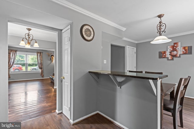 701 Hunters Run, Perkasie, PA 18944 - kitchen with a kitchen breakfast bar, dark wood-style floors, a chandelier, crown molding, and decorative light fixtures