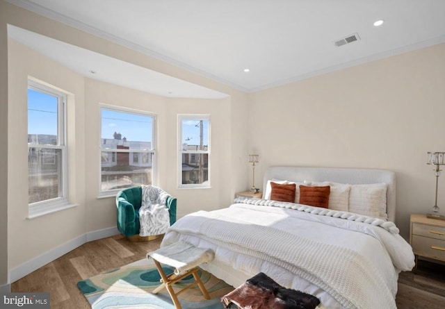 5717 Larchwood Ave, Philadelphia, PA 19143 - bedroom with wood finished floors, multiple windows, crown molding, and recessed lighting