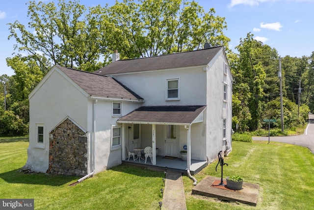 2397 Hill Rd, Perkiomenville, PA 18074 - view of front facade featuring stucco siding, covered porch, a front yard, and a shingled roof