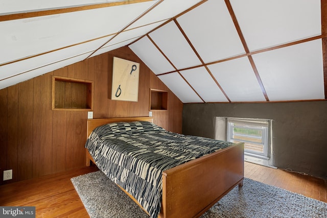 2397 Hill Rd, Perkiomenville, PA 18074 - bedroom featuring light wood-style floors, wood walls, and vaulted ceiling