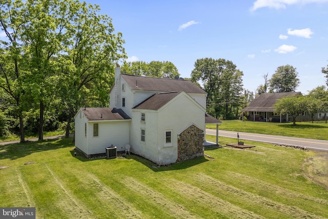 2397 Hill Rd, Perkiomenville, PA 18074 - rear view of property featuring a lawn, a chimney, stucco siding, and roof with shingles