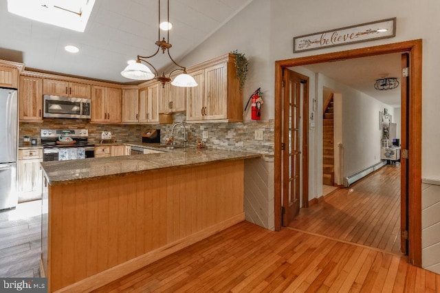 99 Old Main Shore Rd, Barnegat, NJ 08005 - kitchen featuring stainless steel appliances, baseboard heating, light wood-style floors, a skylight, and tasteful backsplash