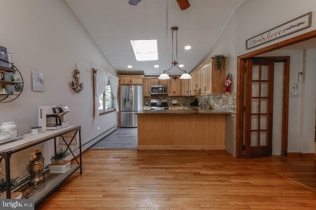 99 Old Main Shore Rd, Barnegat, NJ 08005 - kitchen with stainless steel appliances, a peninsula, a skylight, light wood-type flooring, and a ceiling fan