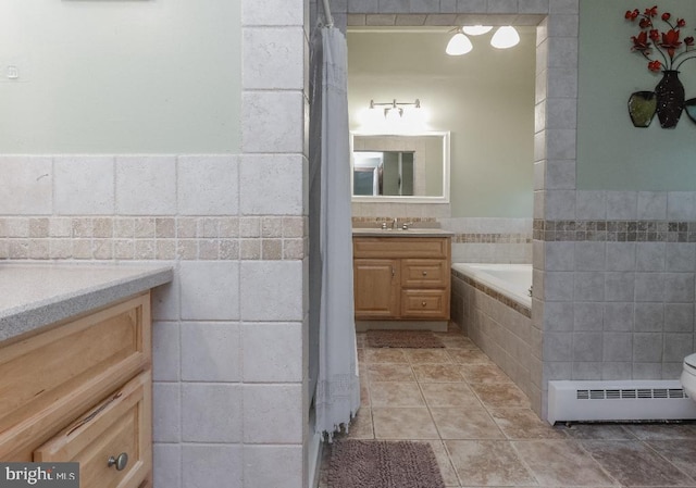 99 Old Main Shore Rd, Barnegat, NJ 08005 - full bath featuring a baseboard radiator, vanity, tile walls, tiled tub, and tile patterned floors