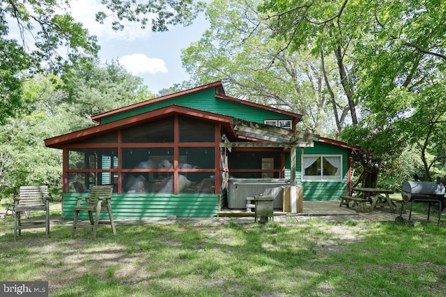 99 Old Main Shore Rd, Barnegat, NJ 08005 - rear view of property with a hot tub, a sunroom, a wooden deck, and a lawn