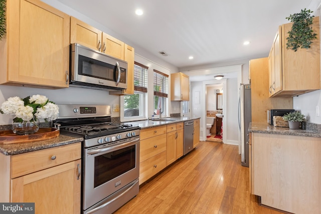 122 Carver Ave, Egg Harbor Township, NJ 08234 - kitchen featuring appliances with stainless steel finishes, light brown cabinetry, light wood finished floors, recessed lighting, and dark stone countertops