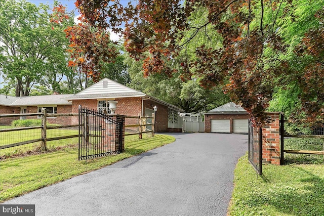 136 Schoolhouse Ln, Glen Mills, PA 19342 - view of front of property with brick siding, a fenced front yard, and a garage