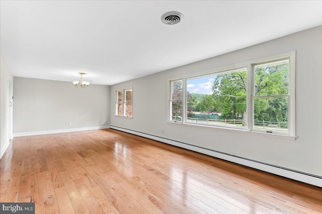 136 Schoolhouse Ln, Glen Mills, PA 19342 - unfurnished room featuring a baseboard radiator, a chandelier, and light wood finished floors