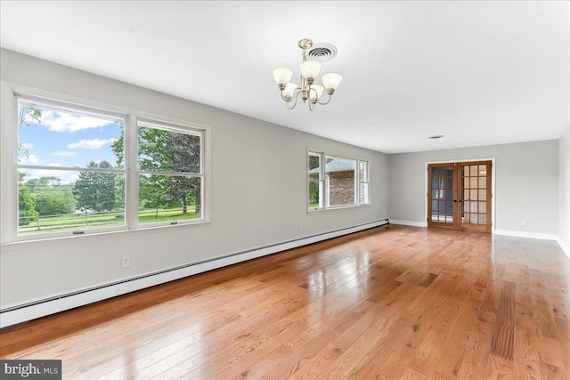 136 Schoolhouse Ln, Glen Mills, PA 19342 - spare room featuring baseboard heating, a chandelier, wood finished floors, and french doors