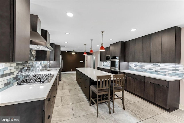136 Schoolhouse Ln, Glen Mills, PA 19342 - kitchen featuring stainless steel appliances, wall chimney exhaust hood, backsplash, dark brown cabinets, and recessed lighting