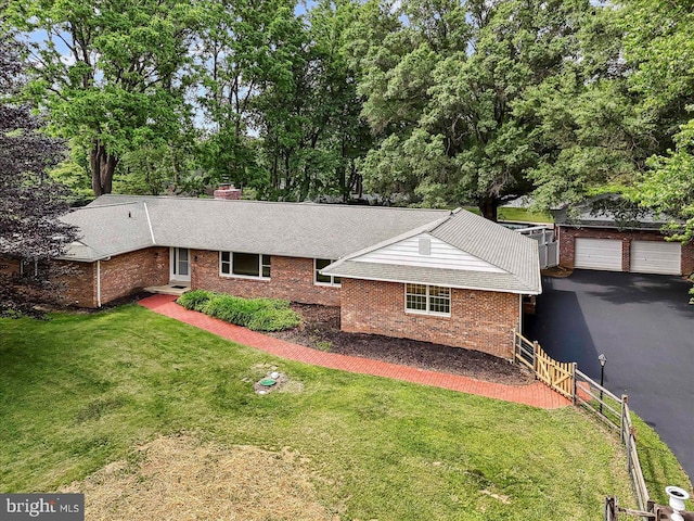 136 Schoolhouse Ln, Glen Mills, PA 19342 - single story home with brick siding, a chimney, a detached garage, and view of scattered trees