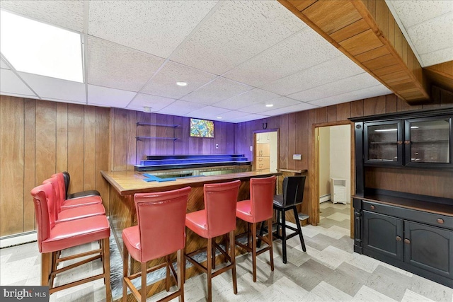 136 Schoolhouse Ln, Glen Mills, PA 19342 - indoor dry bar featuring wooden walls, light floors, a paneled ceiling, and a baseboard radiator