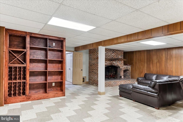 136 Schoolhouse Ln, Glen Mills, PA 19342 - living room with a drop ceiling, wooden walls, and a brick fireplace