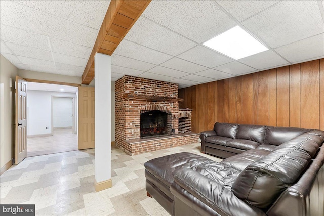 136 Schoolhouse Ln, Glen Mills, PA 19342 - living area with light flooring, a paneled ceiling, wooden walls, and a fireplace