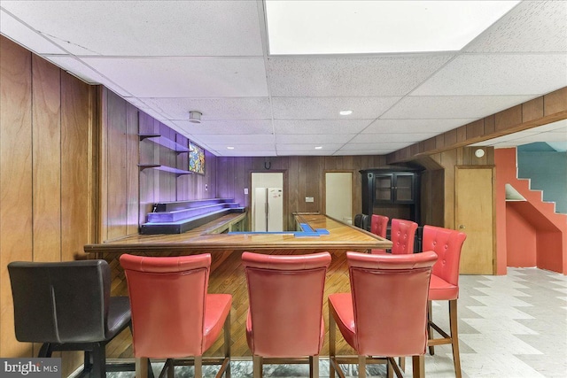 136 Schoolhouse Ln, Glen Mills, PA 19342 - indoor dry bar featuring wooden walls, a paneled ceiling, tile patterned floors, and stairway